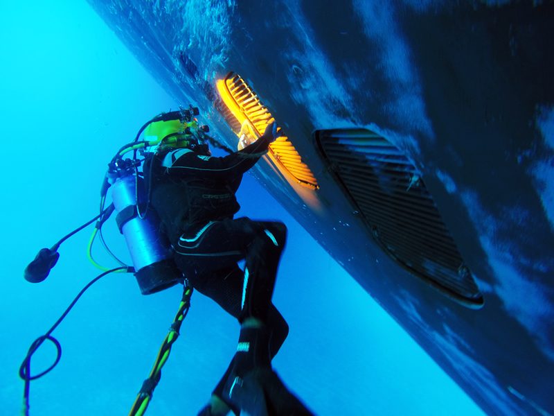 Diver with hull cleaning brush