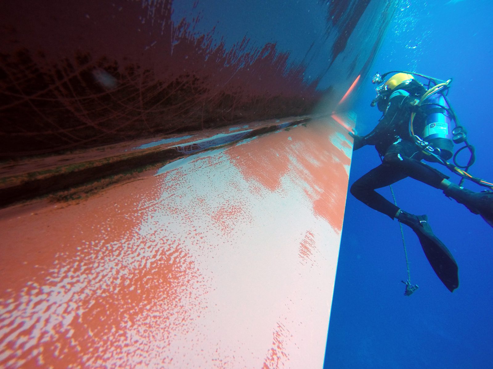 Diver cleaning a tanker hull
