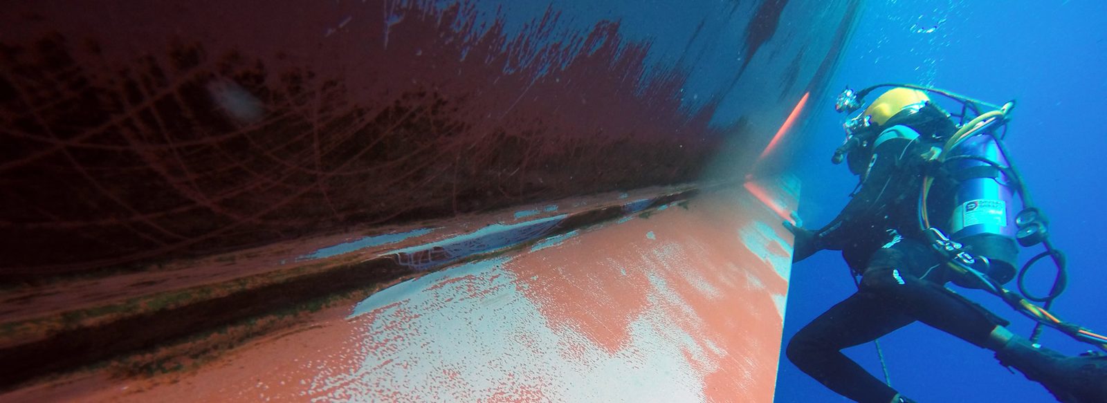Diver cleaning a ship's hull